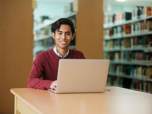 istock Latin male college student smiling at camera 1135517377
