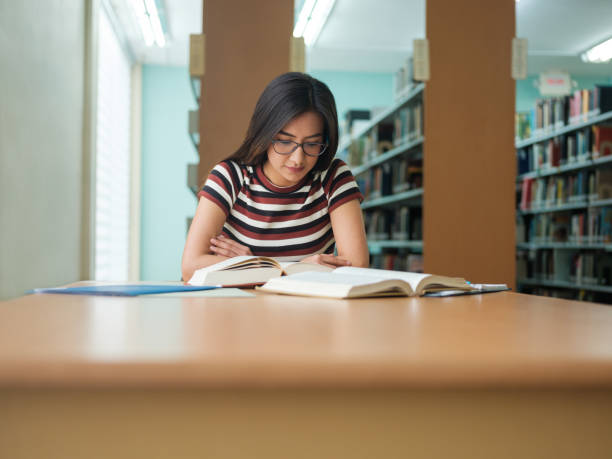 istock Latin college girl reading 1135517400
