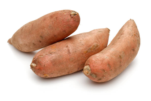 istock Whole sweet potatoes isolated on white 1135517445