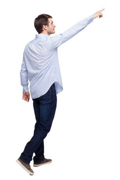 istock Back view of a man walking with a pointing hand. 1135518260