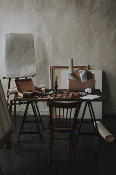 istock Table with artistic tools and chair in front of it 1135519621