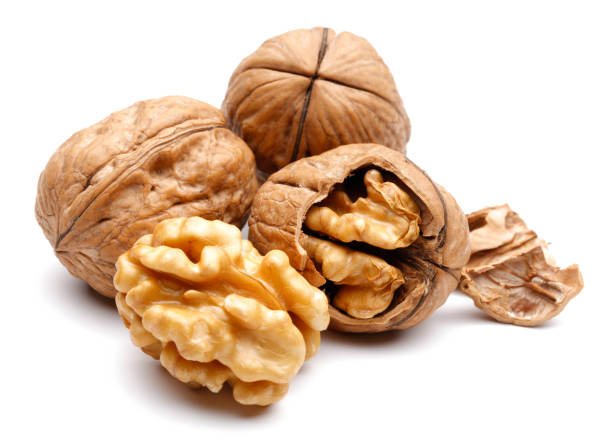 istock Whole and cracked walnuts isolated on white 1135519811