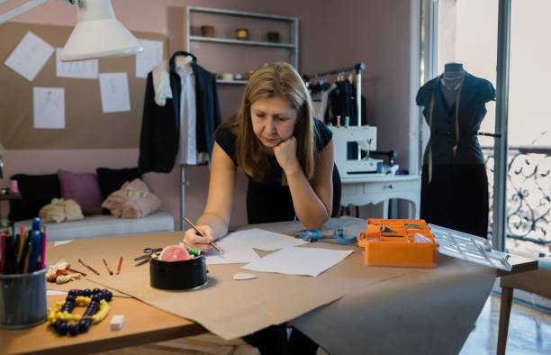 istock Female fashion designer working in her art studio 1135521137