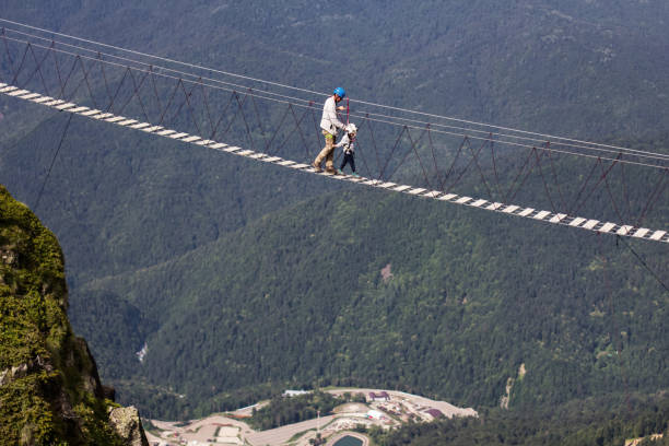 istock man and boy in the mountains on an extreme walk 1135521235