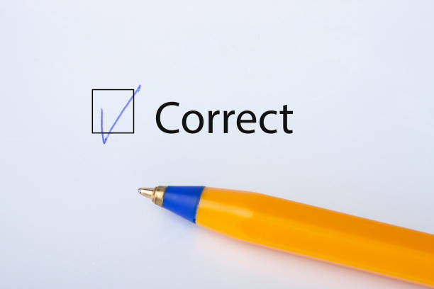 istock Correct - checkbox with a tick on white paper with yellow pen. Checklist concept. 1135521508