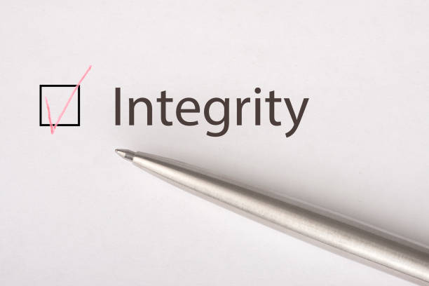 istock Integrity - checkbox with a tick on white paper with metal pen. Checklist concept. 1135521547