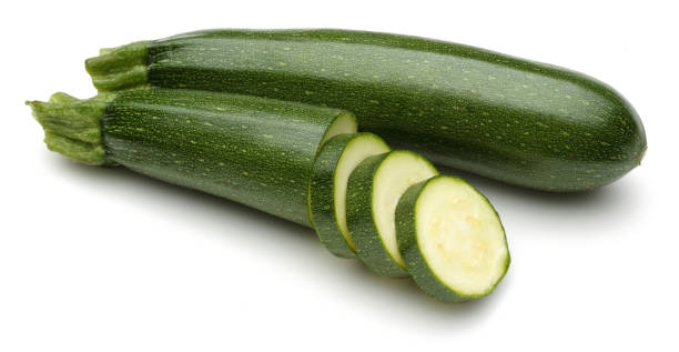 istock Green zucchini with slices isolated on white 1135521588