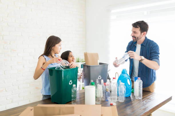 istock Environmentally Conscious Family Collecting Bottles 1135521715