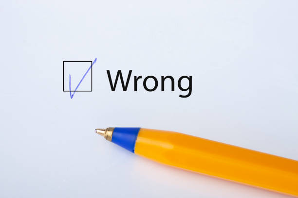 Wrong - checkbox with a tick on white paper with yellow pen. Checklist concept.