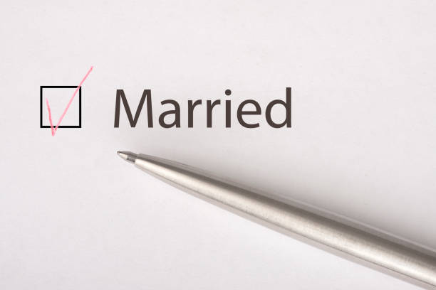 istock Married - checkbox with a tick on white paper with metal pen. Checklist concept. 1135521956