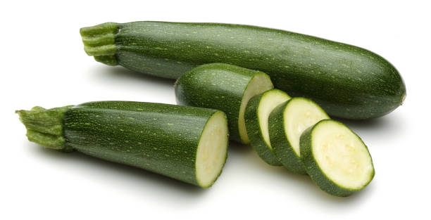 istock Green zucchini with slices isolated on white 1135522182