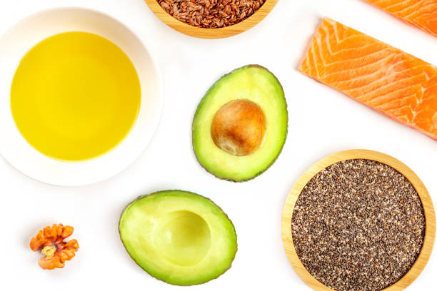 a closeup photo of the ingredients of a healthy omega-3 diet. raw salmon, avocado, nuts, chia and flax seeds, shot from above on a white background - nutritional supplement salmon food flax imagens e fotografias de stock
