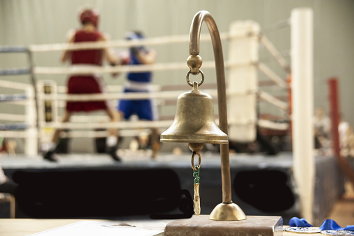 Judge's bell on the background of a boxing match