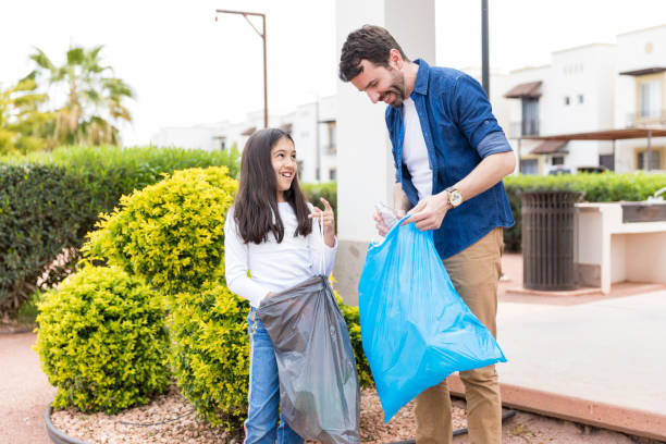 cleaning trash and showing respect for the environment - sustainable resources environment education cleaning imagens e fotografias de stock