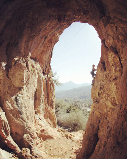 istock Girl rock climber climbs difficult route on the cliffs 1135523861