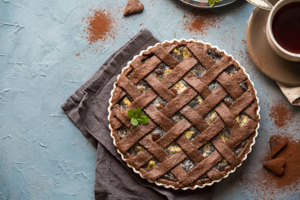Chocolate foot Breakfast with a chocolate pie
made from integral flour (only) stuffed with: apples, pears, poppy seed, raisins. crostata photos stock pictures, royalty-free photos & images