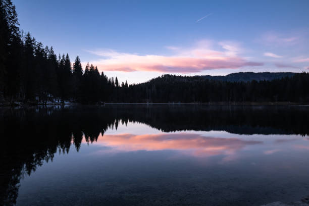 istock scenic mirror reflection on fusine lakes in sunset, italy 1135527549