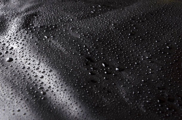 istock Water drops on black leather, dark natural background 1135529994