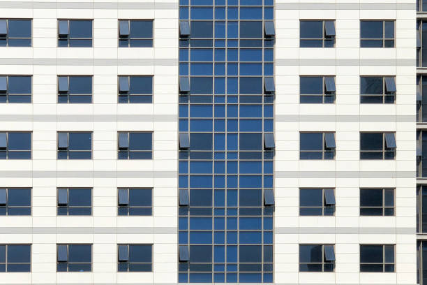 istock Glass windows of white office building background 1135530051