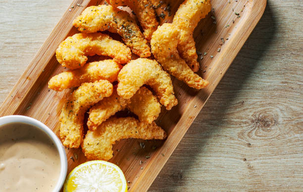 istock Fried Shrimp with sauce and lemon on wooden table background 1135530901