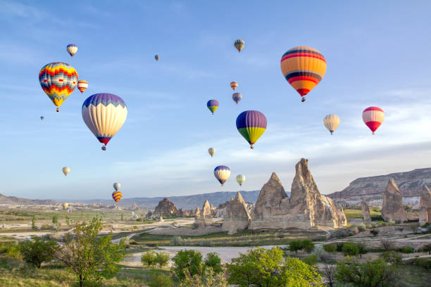 Hot air balloons in the sky over the cave town, Valley of Daggers, Cappadocia, Turkey stock photo