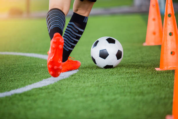 istock soccer player jogging with trap and control football 1135531578
