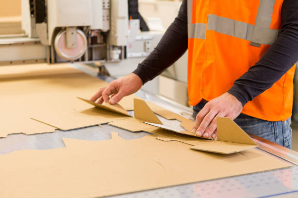 Folding cardboard at the printing plant Man Folding cardboard at the printing plant folding box stock pictures, royalty-free photos & images