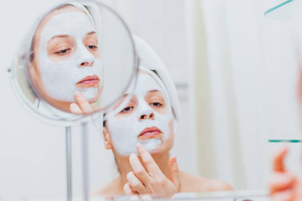 istock Young woman putting a mask on her face 1135533820
