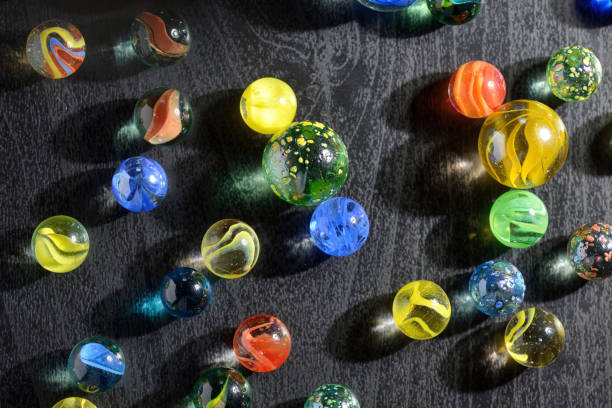 istock Glass marble balls and shadows on table 1135535890
