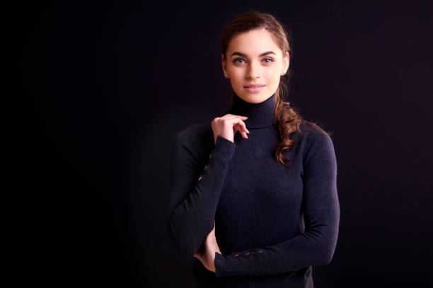 istock Beautiful smiling woman posing at isolated black background 1135537048