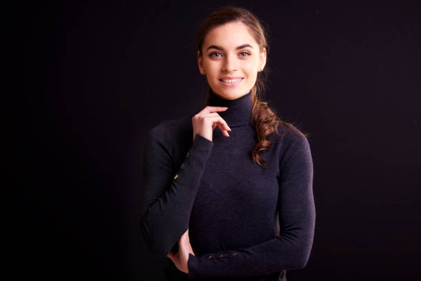 istock Beautiful smiling woman posing at isolated black background 1135537771