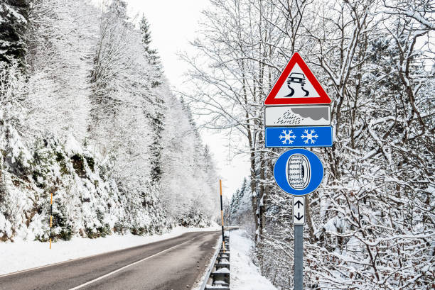 istock European Triangular Warning Sign on a Mountain Road through a Forest Covered in Snow on a Winter Day 1135538669