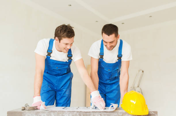istock group of builders with blueprint 1135539468