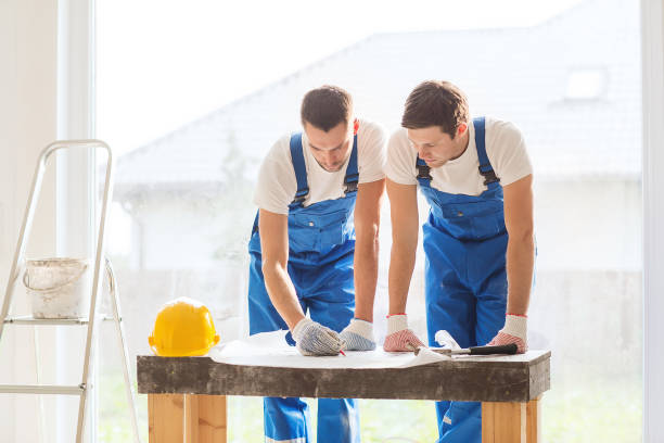 istock group of builders with blueprint 1135539500
