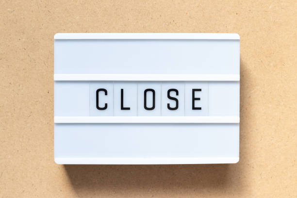 istock White lightbox with word close on wood background 1135539611