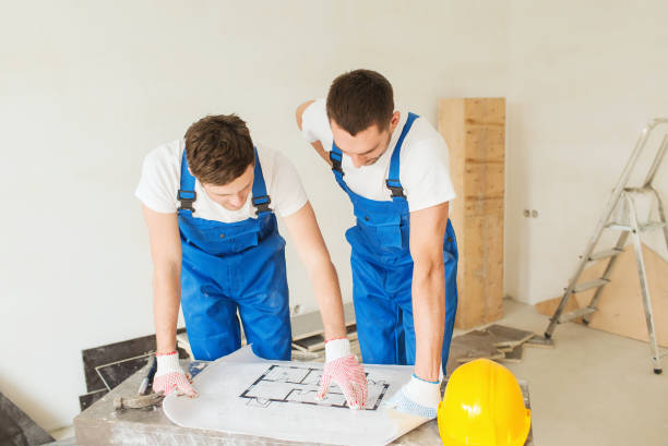 istock group of builders with blueprint 1135539654