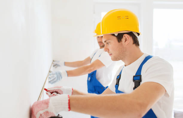 istock group of builders with measuring tape indoors 1135539868