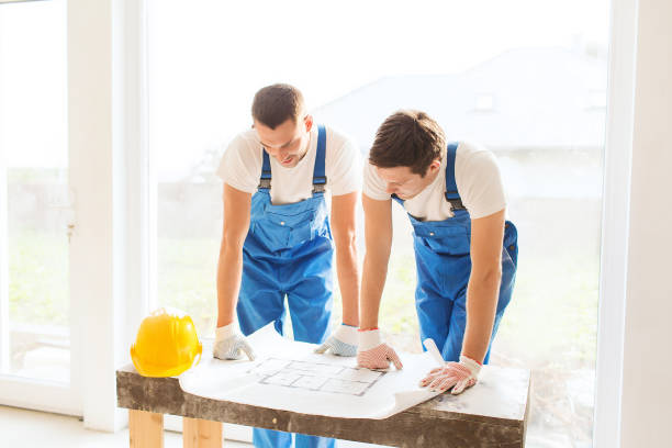 istock group of builders with blueprint 1135539914