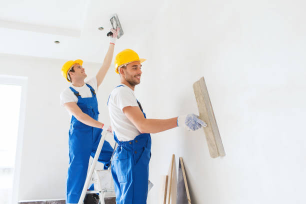 istock group of builders with tools indoors 1135540103