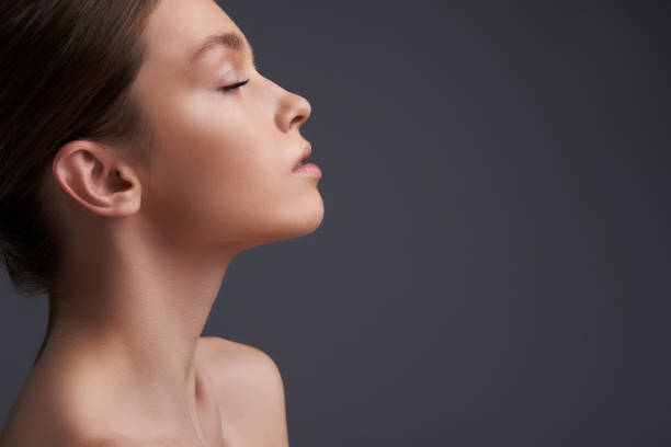 istock Beautiful girl feeling calm and peaceful while standing against gray background 1135540302
