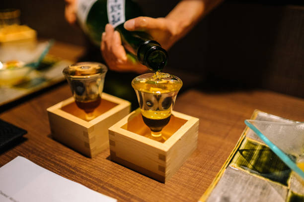 Nihonshu Overflow Sake in a Masu Japanese Tradition saki photos stock pictures, royalty-free photos & images