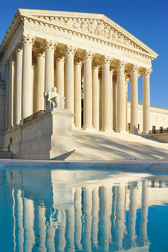 Daytime view of the Supreme Court Building. A neoclassical building with a marble facade, it was designed by architect Cass Gilbert and completed in 1935. Located east of the United States Capitol, it houses the Supreme Court of the United States. It was designated a National Historic Landmark in 1987.
