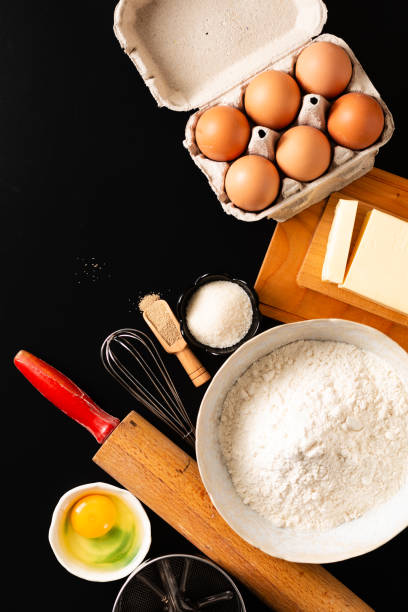 istock Food preparation concept over head shot kitchen tools for Kneading dough for bakery, pizza or pasta on black background with copy space 1135544619