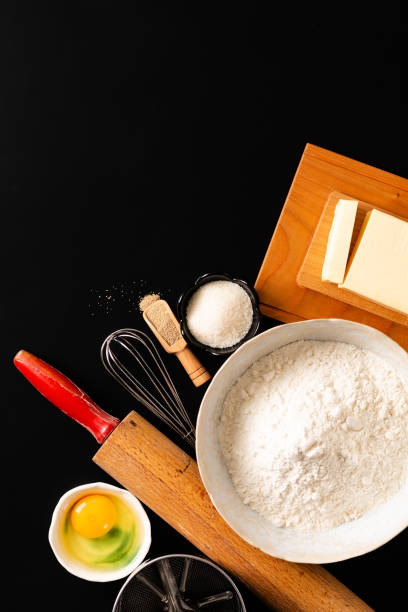 istock Food preparation concept over head shot kitchen tools for Kneading dough for bakery, pizza or pasta on black background with copy space 1135546994
