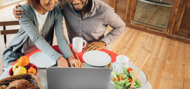 istock Black couple in kitchen ordering food online from restaurant 1135547520