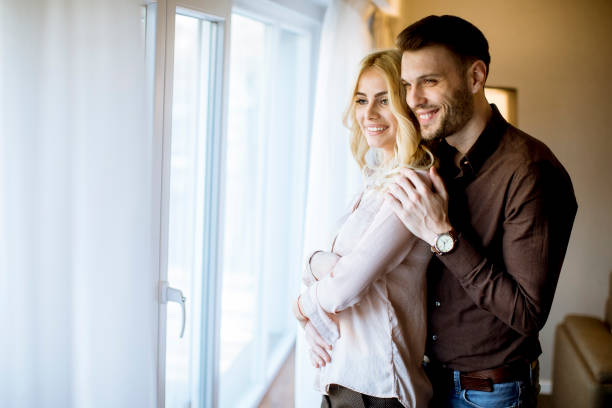 istock Happy loving couple near window 1135547534