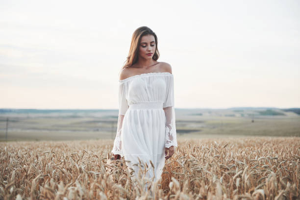 istock Happy young girl in a wheat field under sunlight. 1135547696