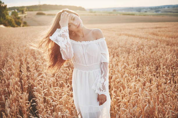 istock Happy young girl in a wheat field under sunlight. 1135547873