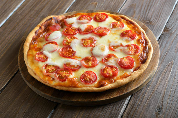 istock Pizza Margarita on wooden cutting board 1135548812