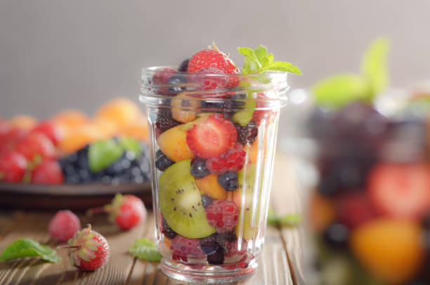 istock Assorted berries in mason jar on kitchen wooden table 1135549260